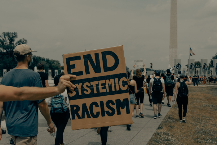 End Systemic Racism written on a sign