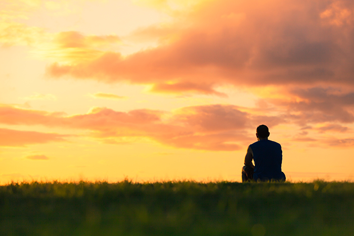 person watching sunset thoughtfully