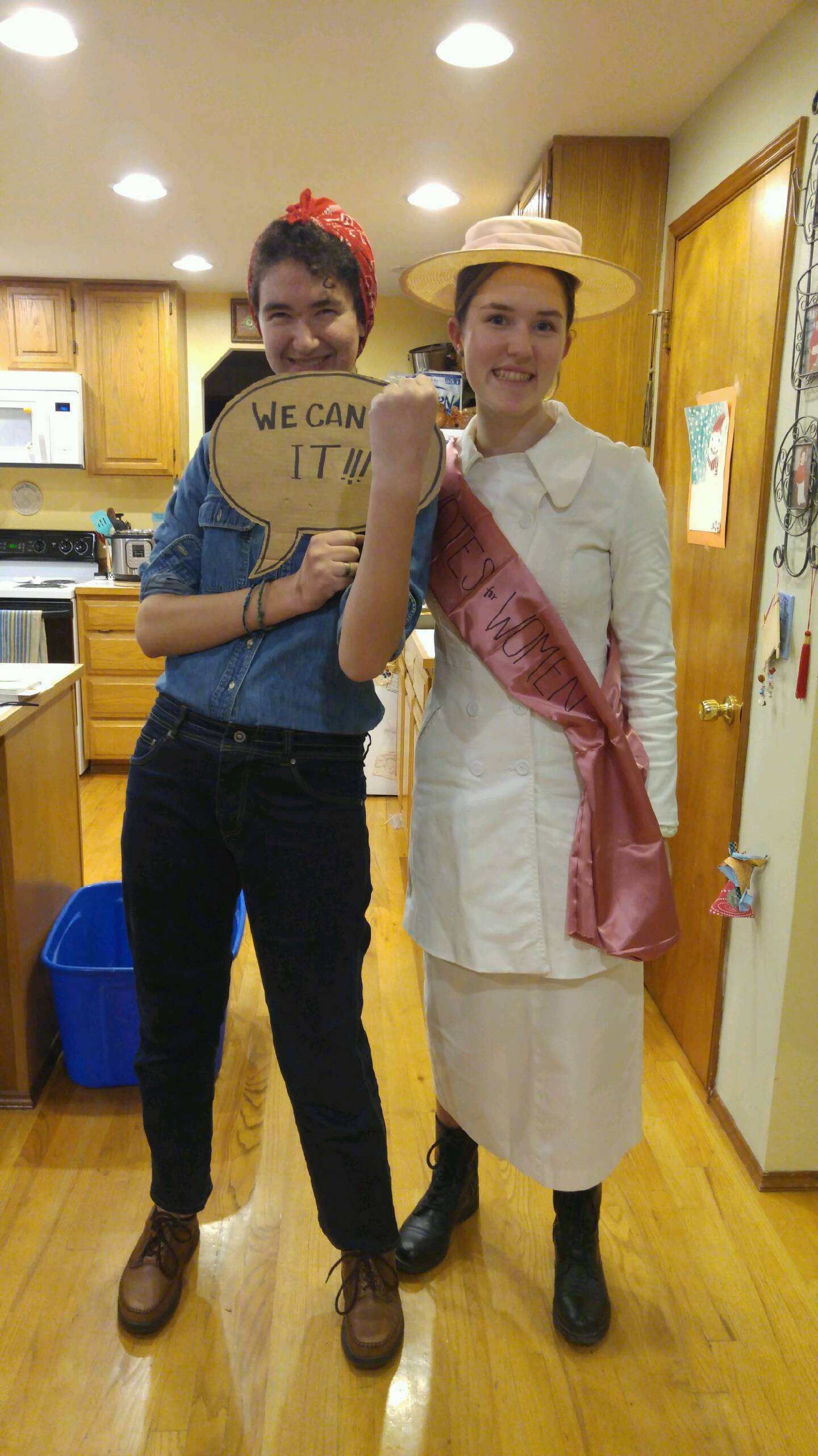 Teens dressed for Halloween as Rosie the Riveter and a suffragette. 