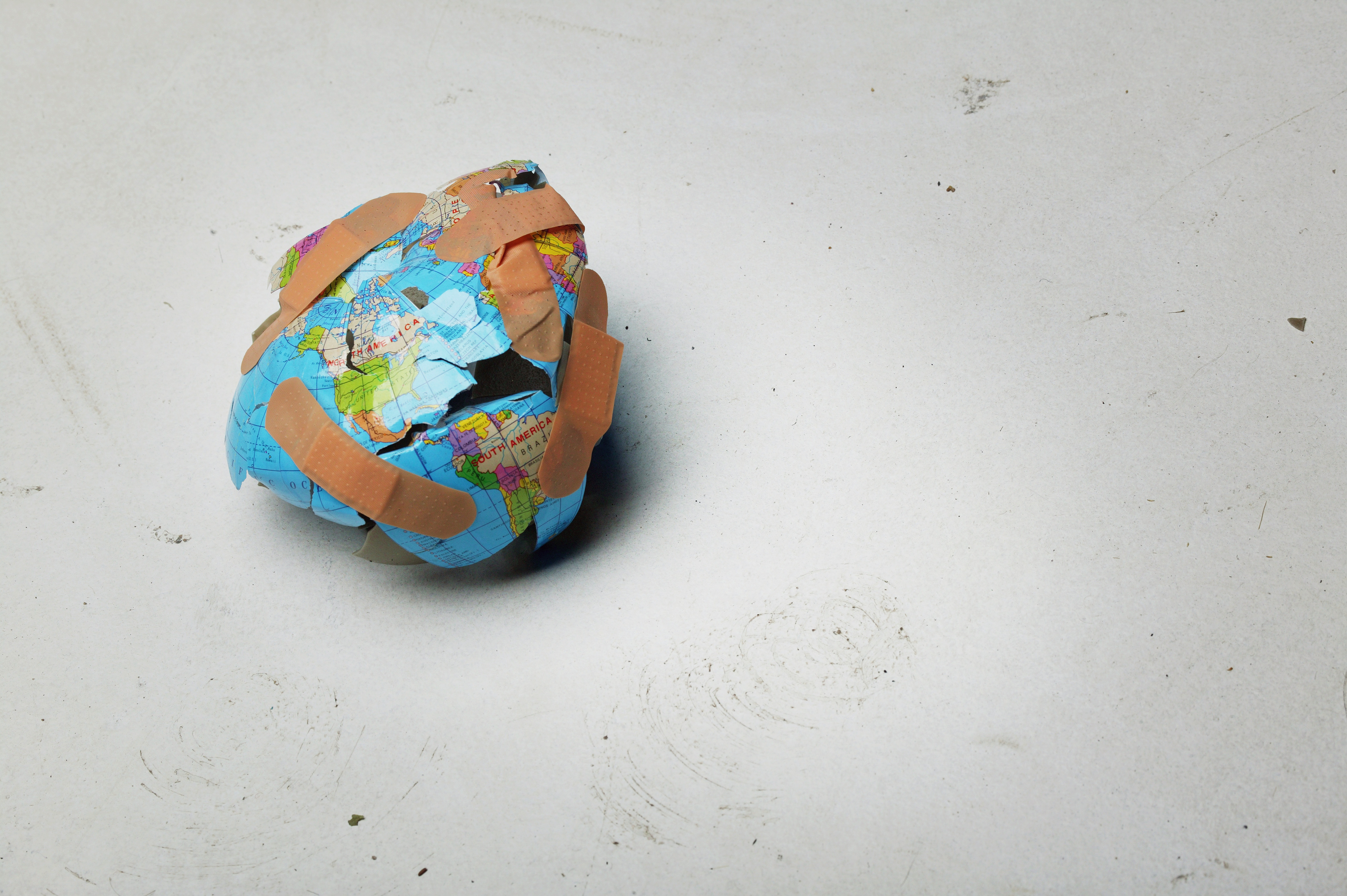 Broken globe held together by bandaids