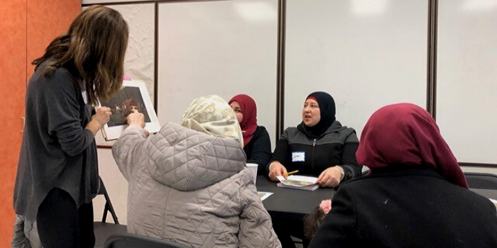 Women in hijabs sitting at at a table