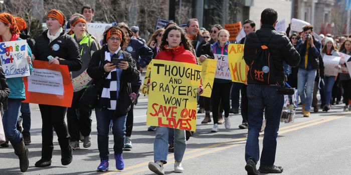 Woman marching with a gun violence prevention sign 