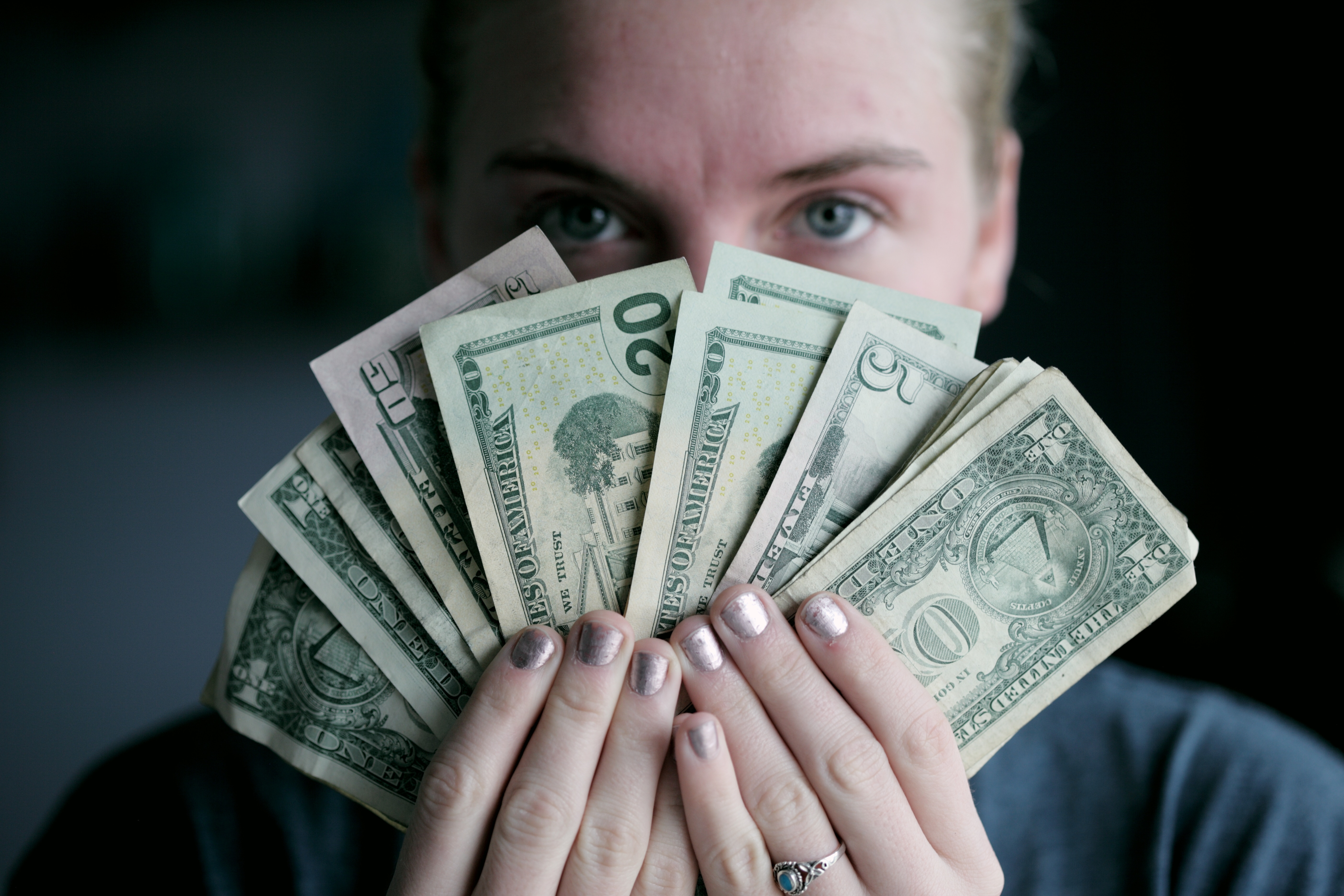 Woman holding dollar bills.