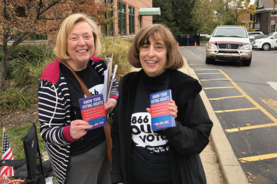 Two people holding brochures that read "Know Your Rights"