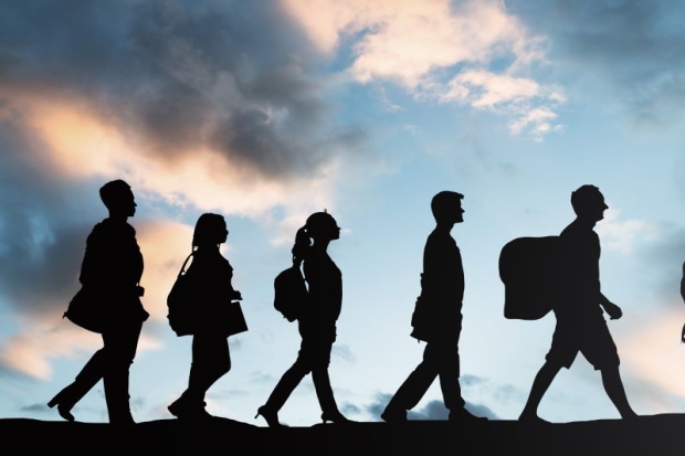 people walking with a blue sky in the background