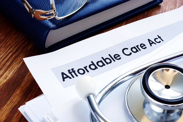 Photo of a piece of paper that says Affordable care act and a stethoscope.