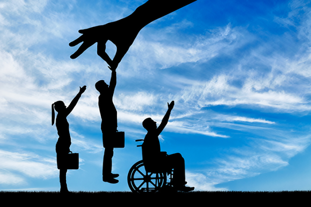 Photo of the silhouette of a person's hand lifting up a healthy worker from a crowd of people and not someone in a wheelchair