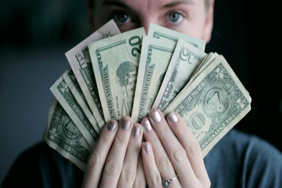 Closeup of a person holding a fanned out handful of money