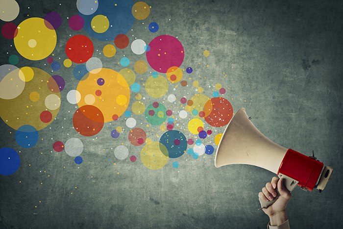 an image of a red and white megaphone with different colored and sized circles coming out of it