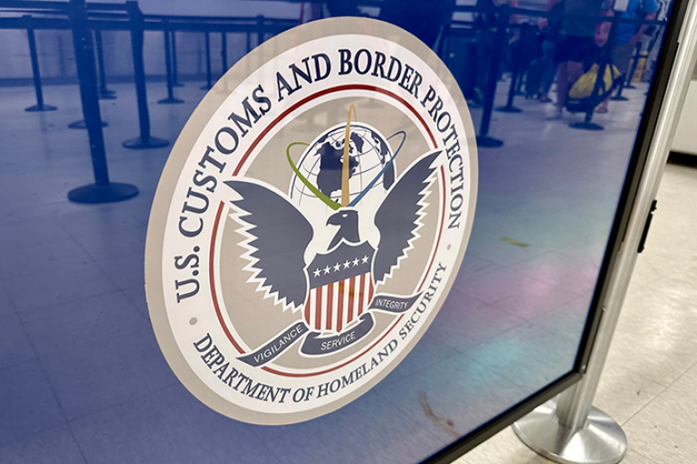 Photo of the U.S. Customs and Border Protection seal on a sign at the airport