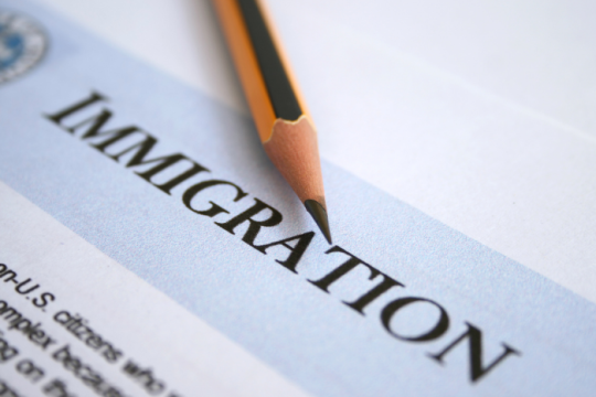 Immigration written on a page with a pencil next to it