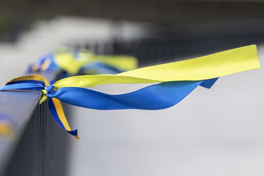 Ribbons in the colors of the Ukrainian flag, tied to a railing