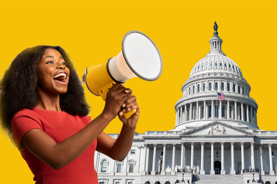 A person talking into a megaphone next to a photo of the US Capitol