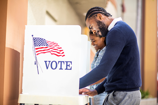 Photo of a man and a woman voting