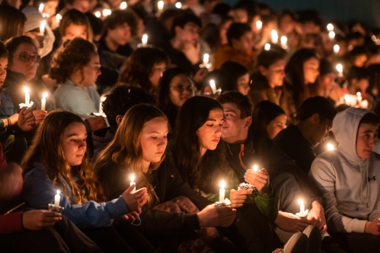 Students holding candles at night to celebrate Havdallah