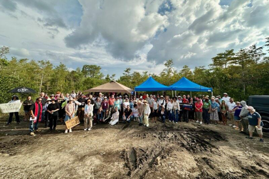 Photo of people at a vigil outside Alligator Alcatraz, a detention camp, in Florida