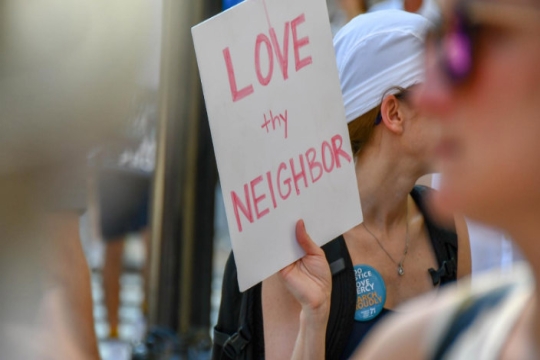 Handmade sign reading LOVE THY NEIGHBOR