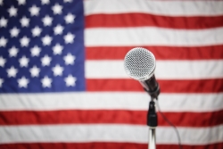 mic on a stand infront of an american flag