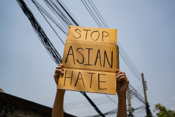 cardboard sign that says Stop Asian Hate