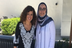 Smiling friends Jewish mom Beth and Muslim mom Alaa who founded an interfaith playgroup 