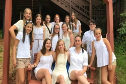 Female summer campers dressed all in white as is customary for Shabbat services at Jewish camp