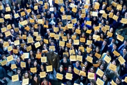 Aerial view of hundreds of teens holding yellow signs that read JEWS DEMAND ACTION