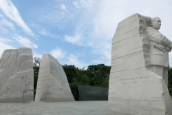 MLK statue in Washington DC against a blue sky 