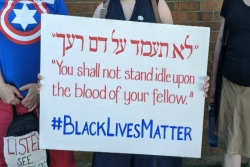 Rabbi holding a sign that says "black lives matter to this rabbi"