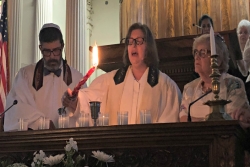 Rabbi Stephanie Alexander leads a Havdallah service behind the bimah with two others 