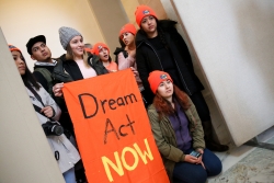 Dreamers holding sign that says DREAM ACT NOW